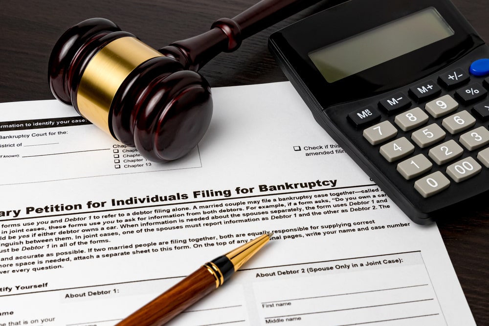 Judges Hammer With Calculator Lying On Bankruptcy Documents